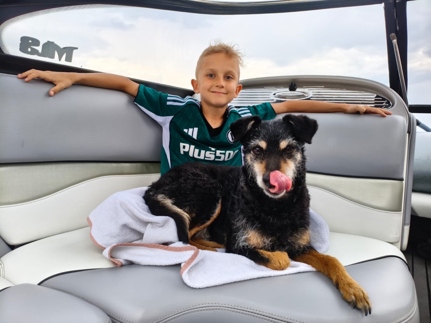 Dziecko z psem na pokładzie łodzi SURFLAB podczas rejsu